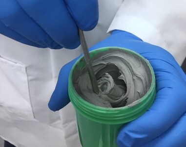 Technician Stirring Solder Paste in Jar